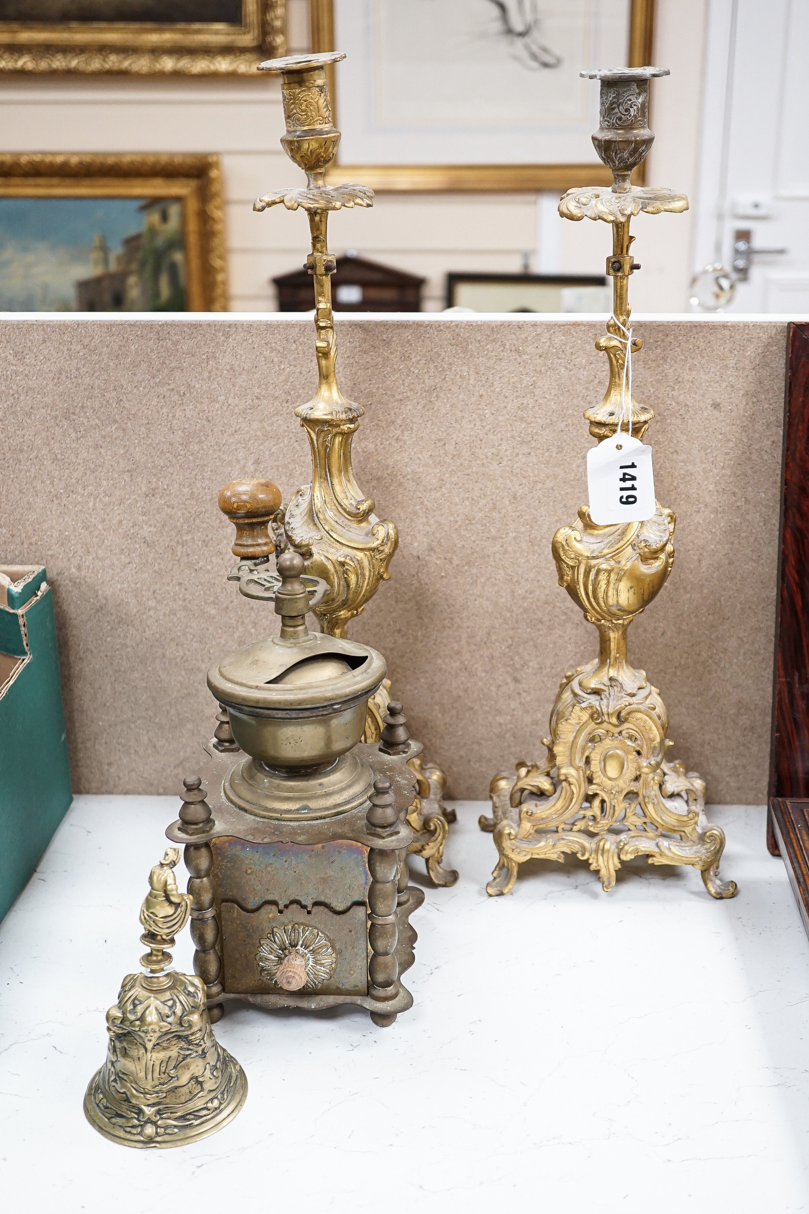 A quantity of bronze and brass wares including a pestle and mortar, candlesticks, coffee grinder etc, tallest items, candlesticks 48 cms high.